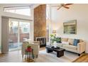 Bright living room with vaulted ceiling, fireplace, and patio access at 2970 W 119Th St, Westminster, CO 80234