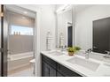 Clean bathroom with double vanity and a shower/tub combo at 6250 W 38Th Ave, Wheat Ridge, CO 80033