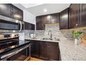 Updated kitchen featuring stainless steel appliances and granite countertops at 8387 S Reed St # B3, Littleton, CO 80128