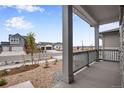 Front porch with gray railing overlooking the quiet street at 3432 N Gold Bug Ct, Aurora, CO 80019