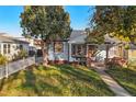 One-story home with front yard and white picket fence at 1340 Xanthia St, Denver, CO 80220