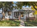 Charming light blue house with brick accents and a manicured lawn at 1340 Xanthia St, Denver, CO 80220