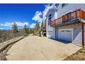 Large concrete driveway with mountain views and home access at 11770 Leavenworth Dr, Conifer, CO 80433