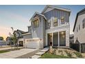 Two-story home with gray siding, white trim, and a covered porch at 11077 Star Fall St, Littleton, CO 80125