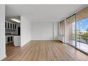 Living room with access to balcony and kitchen at 3100 E Cherry Creek S Dr # 307, Denver, CO 80209