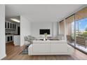 Living room with balcony access and kitchen at 3100 E Cherry Creek S Dr # 307, Denver, CO 80209