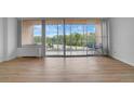 Bright living room with hardwood floors and sliding glass doors leading to a balcony at 3100 E Cherry Creek S Dr # 307, Denver, CO 80209