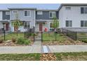 Townhouse exterior with a red door and small front yard at 635 Stonebridge Dr, Longmont, CO 80503