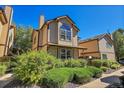 Tan two-story townhome with landscaping and walkway at 1736 S Pagosa Way, Aurora, CO 80017