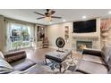 Living room featuring a fireplace, comfortable seating and a large TV at 1736 S Pagosa Way, Aurora, CO 80017