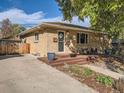 Brick ranch home with a wooden deck and landscaping at 4565 S Fox St, Englewood, CO 80110