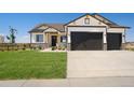 Modern farmhouse exterior with two-car garage and manicured lawn at 24113 E 36Th Pl, Aurora, CO 80019
