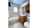 Clean bathroom with shower/tub combo and wood vanity at 5555 Krameria St, Commerce City, CO 80022