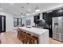 Modern kitchen with island, stainless steel appliances, and dark cabinetry at 2010 Pearl St # B, Boulder, CO 80302