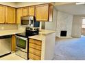 Kitchen with stainless steel appliances and view to living room at 3345 S Ammons St # 5-208, Lakewood, CO 80227