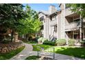 Exterior view of the condo building with landscaping and walkways at 8378 S Upham Way # B301, Littleton, CO 80128