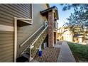 Side view of townhome with stairs leading to upper level at 3233 S Zeno Ct # C, Aurora, CO 80013