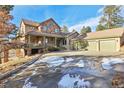 Inviting home with stone and stucco exterior, large driveway, and covered front porch at 5519 Ponderosa Dr, Parker, CO 80134