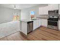 Open concept kitchen with island, stainless steel appliances and granite countertops at 2225 Alyssa St, Fort Lupton, CO 80621