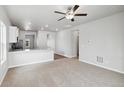 Spacious living room with carpeting and ceiling fan at 2225 Alyssa St, Fort Lupton, CO 80621