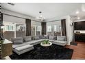 Spacious living room with large sectional sofa and big windows at 10226 Worchester St, Commerce City, CO 80022