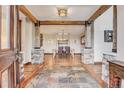 Elegant entryway with stone pillars, hardwood floors, and a view to the dining room at 3864 Valley Dr, Evergreen, CO 80439
