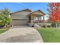House exterior features a two-car garage and a covered porch at 7030 S Buchanan St, Aurora, CO 80016