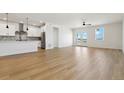 Spacious living room with light hardwood floors and access to a patio at 42986 Colonial Trl, Elizabeth, CO 80107