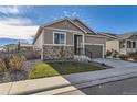 Single story home with stone and siding exterior, two-car garage at 6954 Greenwater Cir, Castle Rock, CO 80108