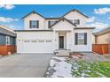 Beautiful two-story home with a classic design, white siding, and black shutters at 1562 Farmstead St, Brighton, CO 80601