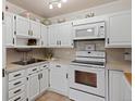 Bright white kitchen with ample cabinetry, built-in microwave, and modern appliances at 750 S Clinton St # 12D, Denver, CO 80247