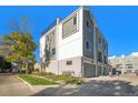 Rear view of modern townhome with garage access at 888 S Valentia St # 104, Denver, CO 80247