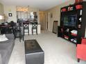 Open-concept living and dining area with entertainment center and kitchen access at 1020 15Th St # 26I, Denver, CO 80202