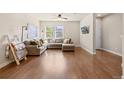 Spacious living room with L-shaped sofa and hardwood floors at 16083 E 47Th Pl, Denver, CO 80239