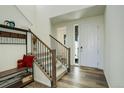 Bright entryway with wood floors and staircase at 4861 St Vrain Rd, Firestone, CO 80504