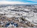 Aerial view of property and surrounding neighborhood in snowy setting at 567 Lake Gulch Rd, Castle Rock, CO 80104