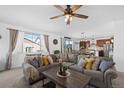 Comfortable living room with sectional sofa and view to kitchen at 26887 E Maple Ave, Aurora, CO 80018