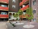 Apartment building entrance with courtyard and landscaping at 3047 W 47Th Ave # 506, Denver, CO 80211