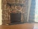 Stone fireplace with a black metal screen at 3355 S Flower St # 157, Lakewood, CO 80227