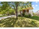Two-story house with front porch, brick exterior and landscaping at 385 N Flat Rock St, Aurora, CO 80018