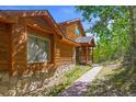 Log home exterior showcasing walkway and landscaping at 10333 Georgia Cir, Morrison, CO 80465