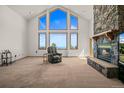 Spacious living room with stone fireplace and large windows at 10333 Georgia Cir, Morrison, CO 80465