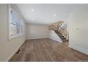 Large living room featuring hardwood floors and a staircase at 1827 Quail St # 3, Lakewood, CO 80215