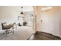 Bright entryway with wood floors, a desk, and a view into the living room at 15535 W Auburn Ave, Lakewood, CO 80228