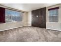 Living room featuring a modern dark-wood accent wall at 4050 S Odessa St, Aurora, CO 80013