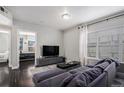 Open concept living area with sectional sofa and view into bedroom at 1623 Saint Paul St # 410, Denver, CO 80206