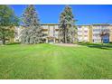 Front view of a two-story apartment building with a well-maintained lawn at 9340 E Center Ave # 8B, Denver, CO 80247