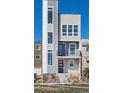 Three-story townhome with modern design and dark-red door at 3654 Penang Dr, Castle Rock, CO 80109