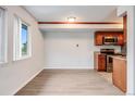 Cozy kitchen with wood cabinets, stainless steel appliances, and granite countertops at 8100 W Quincy Ave # B12, Littleton, CO 80123