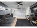 Living room with gray couch, ceiling fan, and tv at 8051 Wolff St # C, Westminster, CO 80031